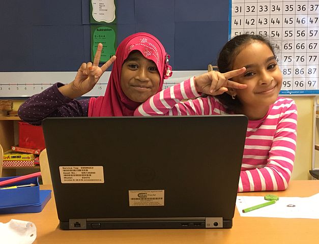 Young students with a laptop.